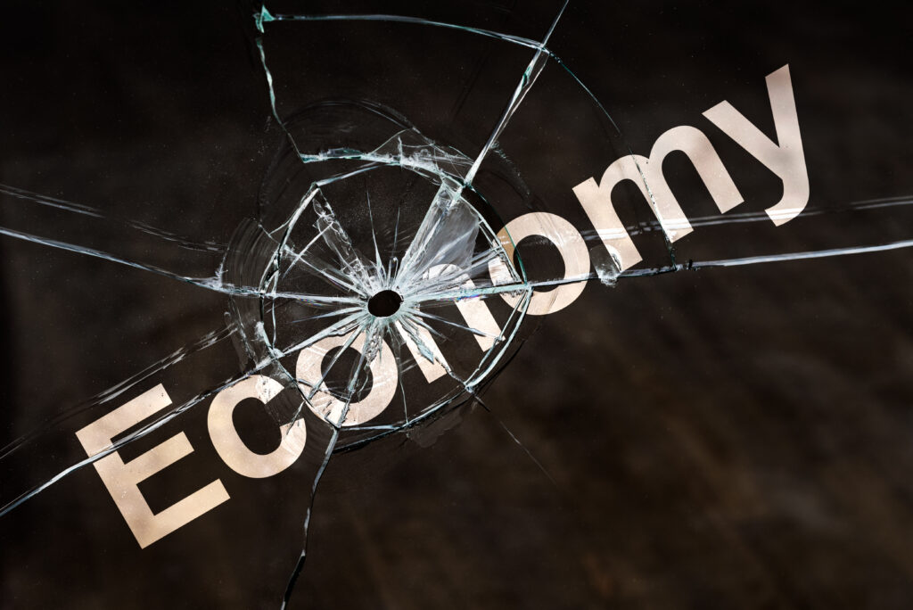 Image depicting the word "economy" with a gunshot, symbolizing the impact of addiction on workforce productivity and economic growth.