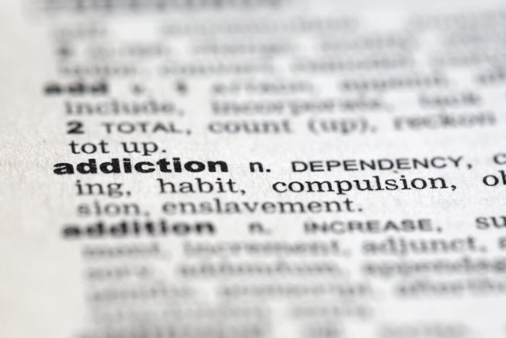 Image depicting the definition of addiction, highlighting its complexity within the context of mental health.