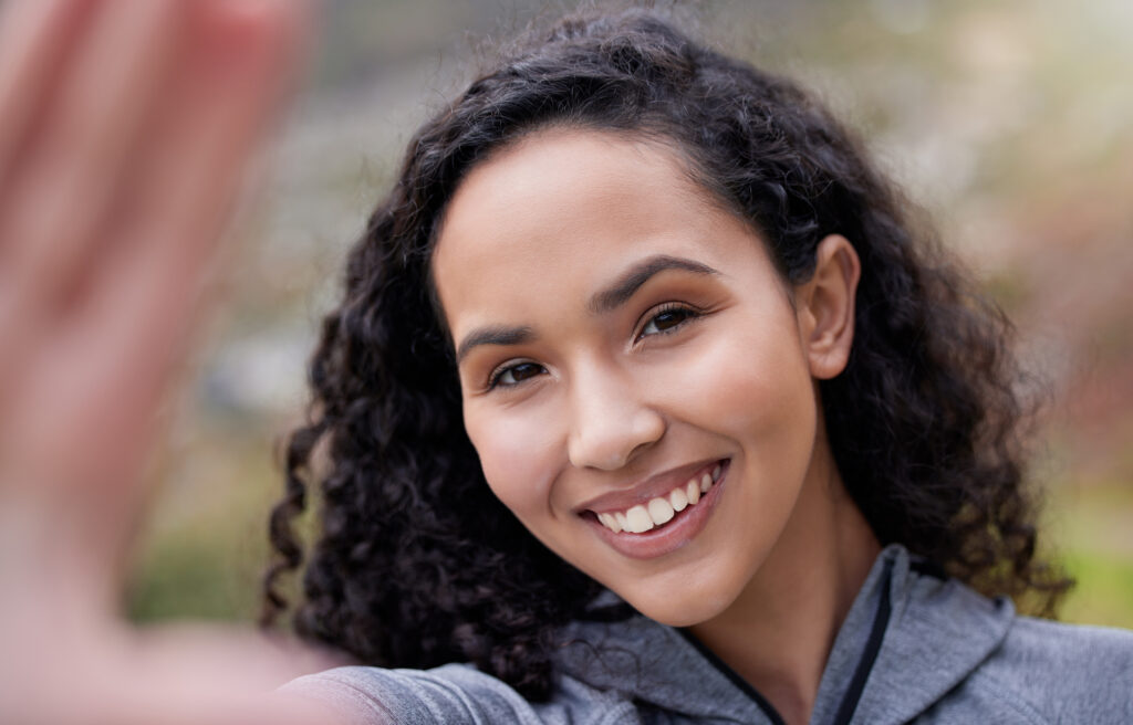 Image of a woman smiling brightly, reflecting the positive impact of personalized care on her well-being.