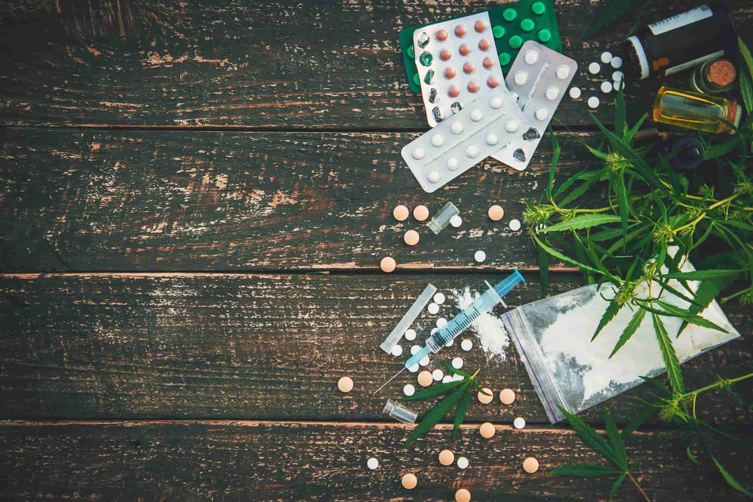 An assortment of illegal drugs and pills, representing the dangers of polysubstance abuse and addiction.