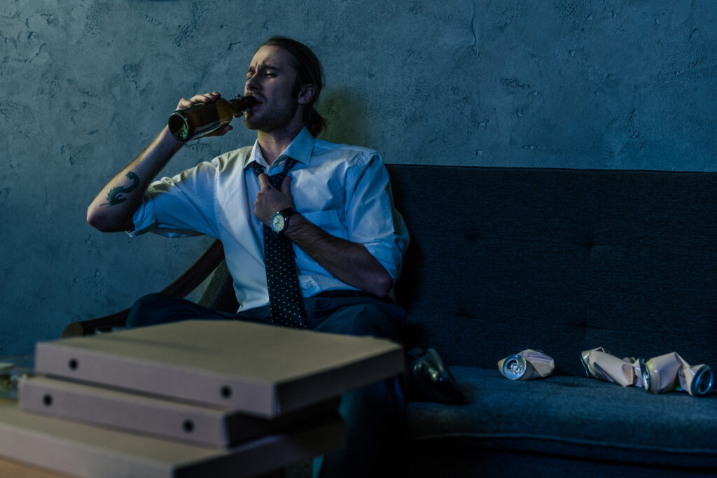 An image of a man drinking alcohol, symbolizing the physical dependence on substances like alcohol. This image captures the torment faced by individuals grappling with addiction, as their bodies adapt to the presence of substances, leading to withdrawal symptoms and increased tolerance.