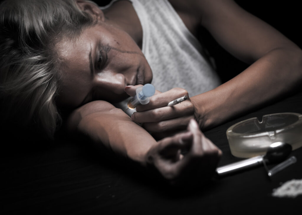 Image featuring a candid portrayal of a young female drug addict, emphasizing the theme of the blog post on Mental Health and Addiction: Unveiling the Myths and Debunking Misconceptions. The title is prominently displayed, symbolizing the focus on breaking down stereotypes and fostering understanding.