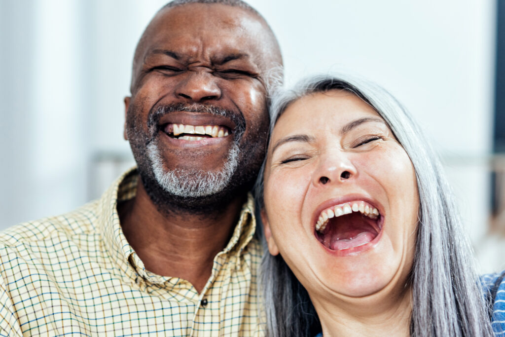 Two people laughing together, embodying genuine happiness, highlighting the link between joy and improved mental health in 'The Science of Happiness' blog.