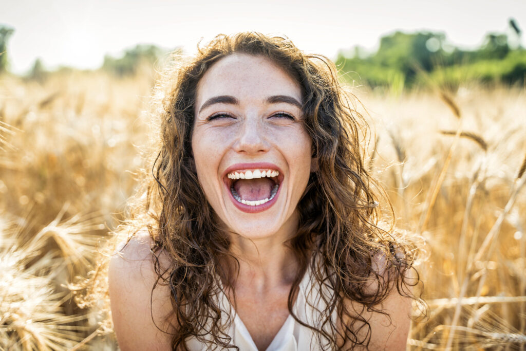 happy beautiful woman smiling in a wheat field 2023 11 27 05 22 19 utc AM Healthcare