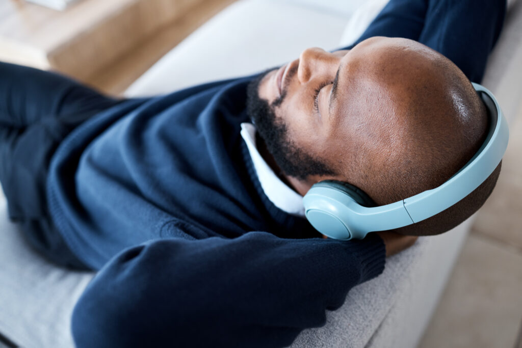 music top view headphones and black man on sofa i 2023 11 27 04 54 30 utc AM Healthcare