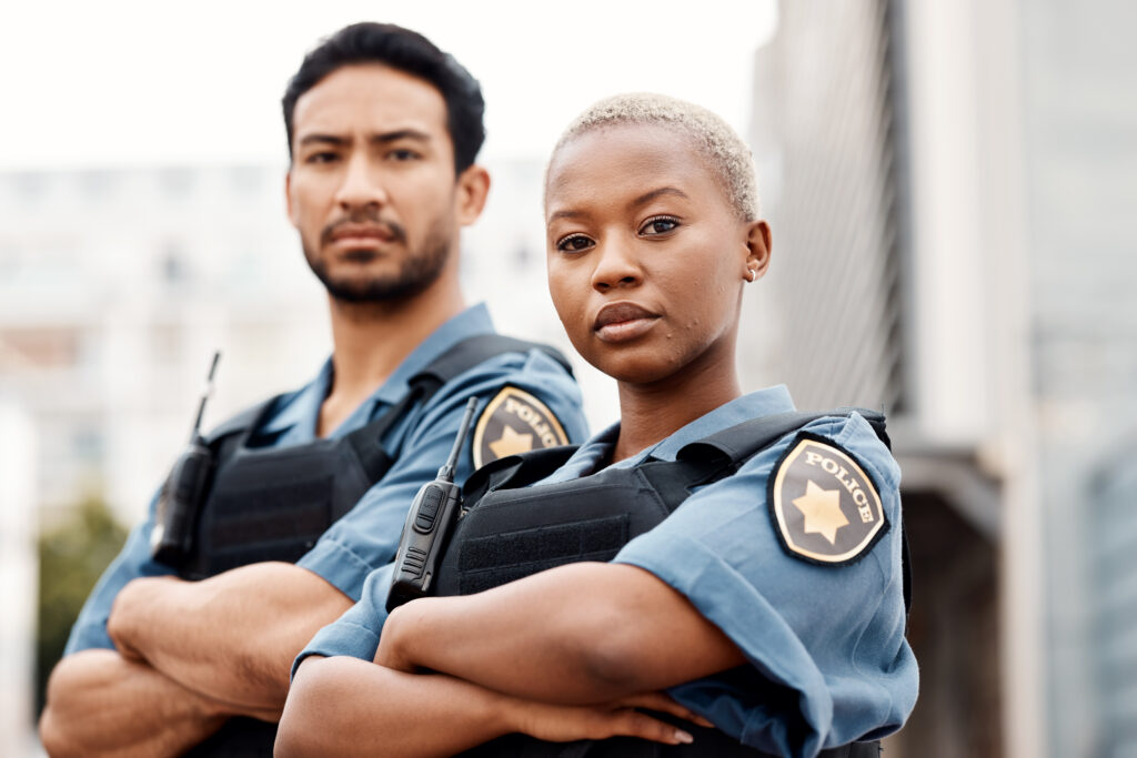 Two police officers with serious expressions, highlighting the impact of repeated trauma in policing. This image accompanies the section discussing the effects of repeated trauma on police officers in the blog.