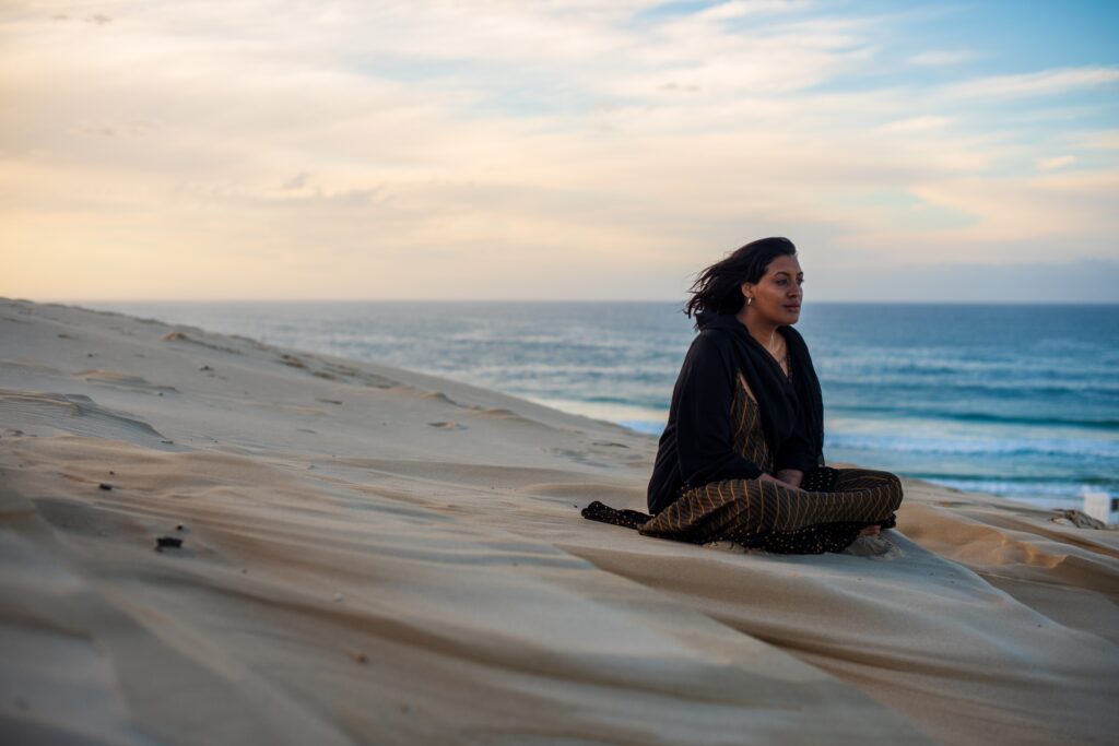 woman seen sitting on sand dune while watching the 2023 11 27 04 53 55 utc AM Healthcare
