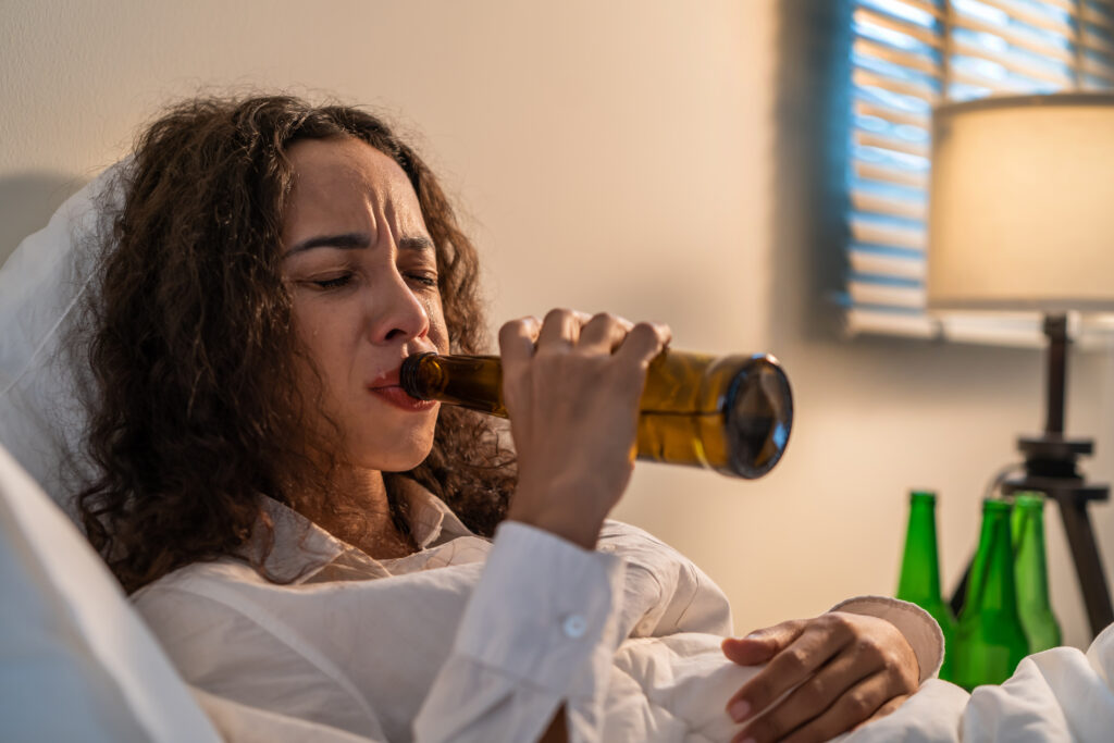 drunk latino woman hold beer bottle and crying fe 2023 11 27 05 29 45 utc AM Healthcare