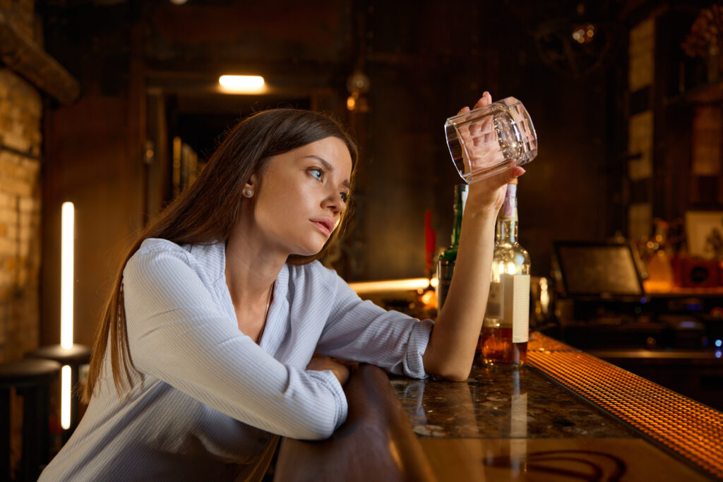 drunk young woman looking into empty glass sitting 2023 12 12 22 26 48 utc AM Healthcare