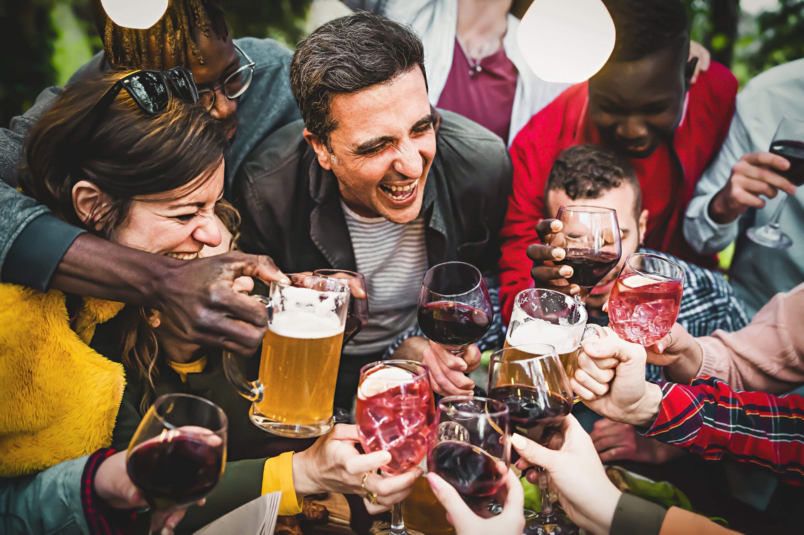 A group of individuals engaging in excessive alcohol consumption, with various alcoholic beverages in hand, during a social gathering.