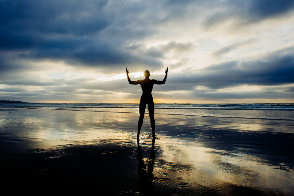 silhouette of person raising arms on beach 2023 11 27 05 01 45 utc AM Healthcare