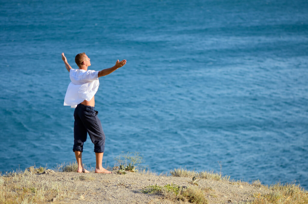 young man enjoying the sea breeze 2023 11 27 05 11 09 utc AM Healthcare