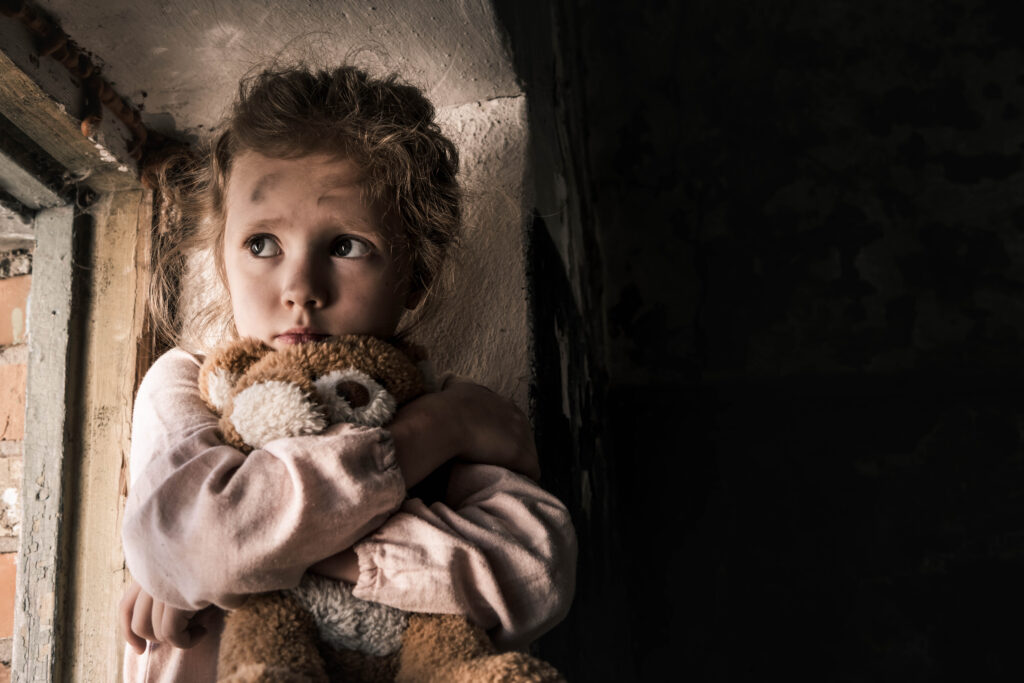 frustrated child holding teddy bear in dirty room 2023 11 27 05 17 05 utc AM Healthcare