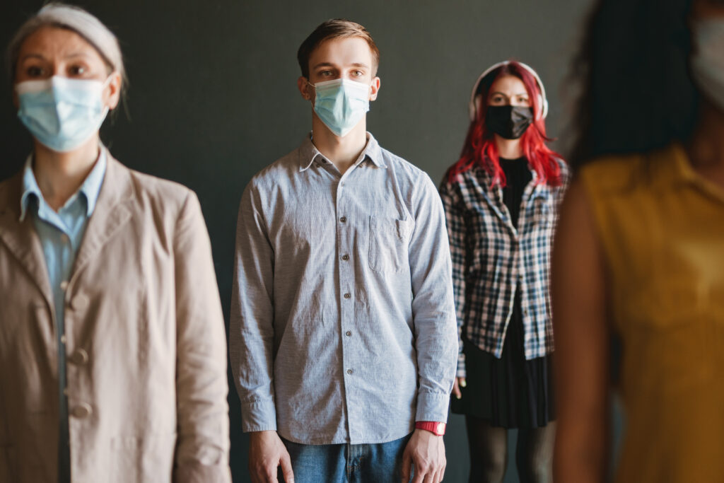 multiracial man and women in face mask looking at 2023 11 27 05 11 47 utc AM Healthcare