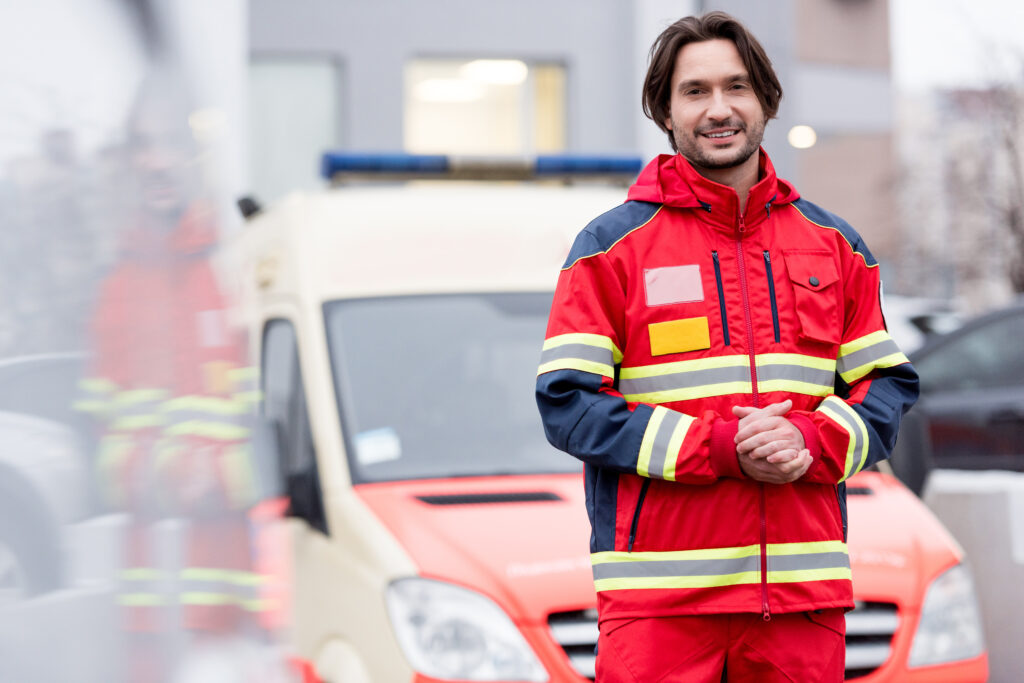 smiling paramedic in uniform standing near ambulan 2023 11 27 05 28 22 utc AM Healthcare