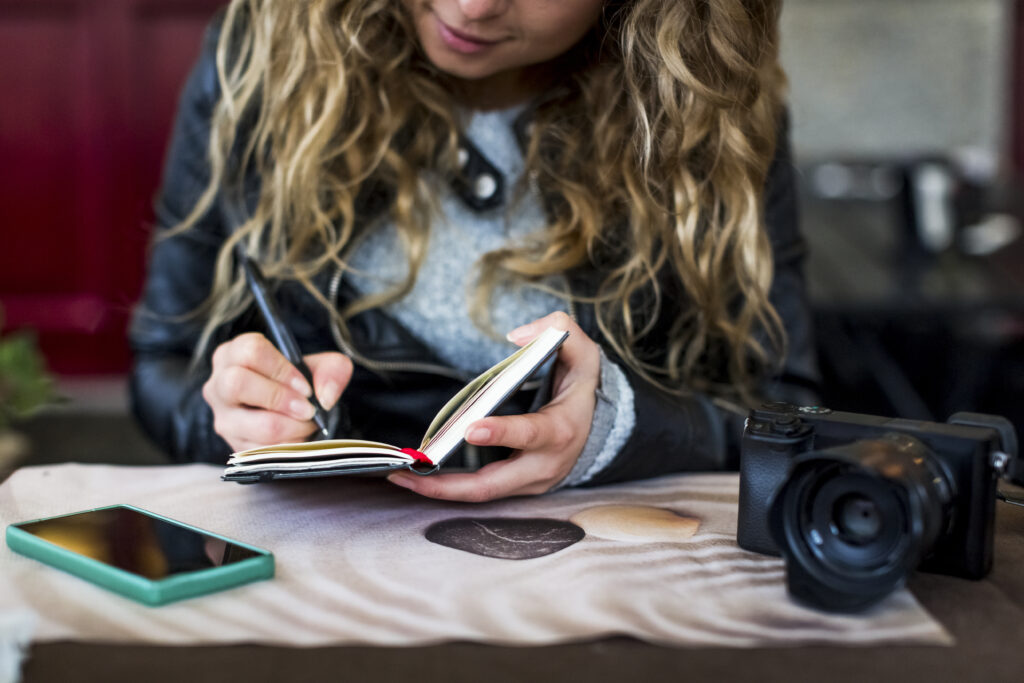 woman at cafe writing in notebook 2023 11 27 04 58 25 utc AM Healthcare