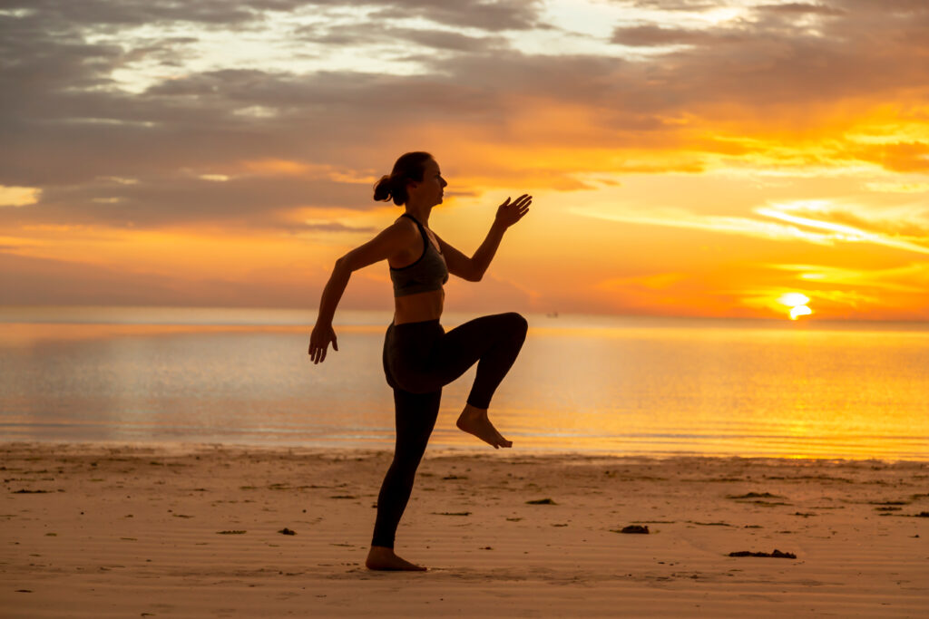 woman doing high knee skipping exercise on the bea 2023 11 27 05 05 41 utc AM Healthcare