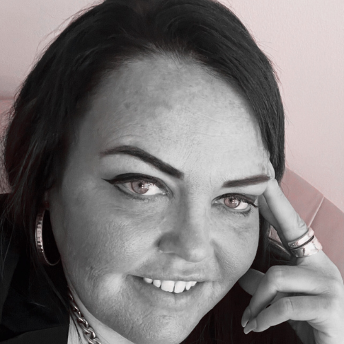 A black and white photo of a female team member, projecting professionalism and empathy.