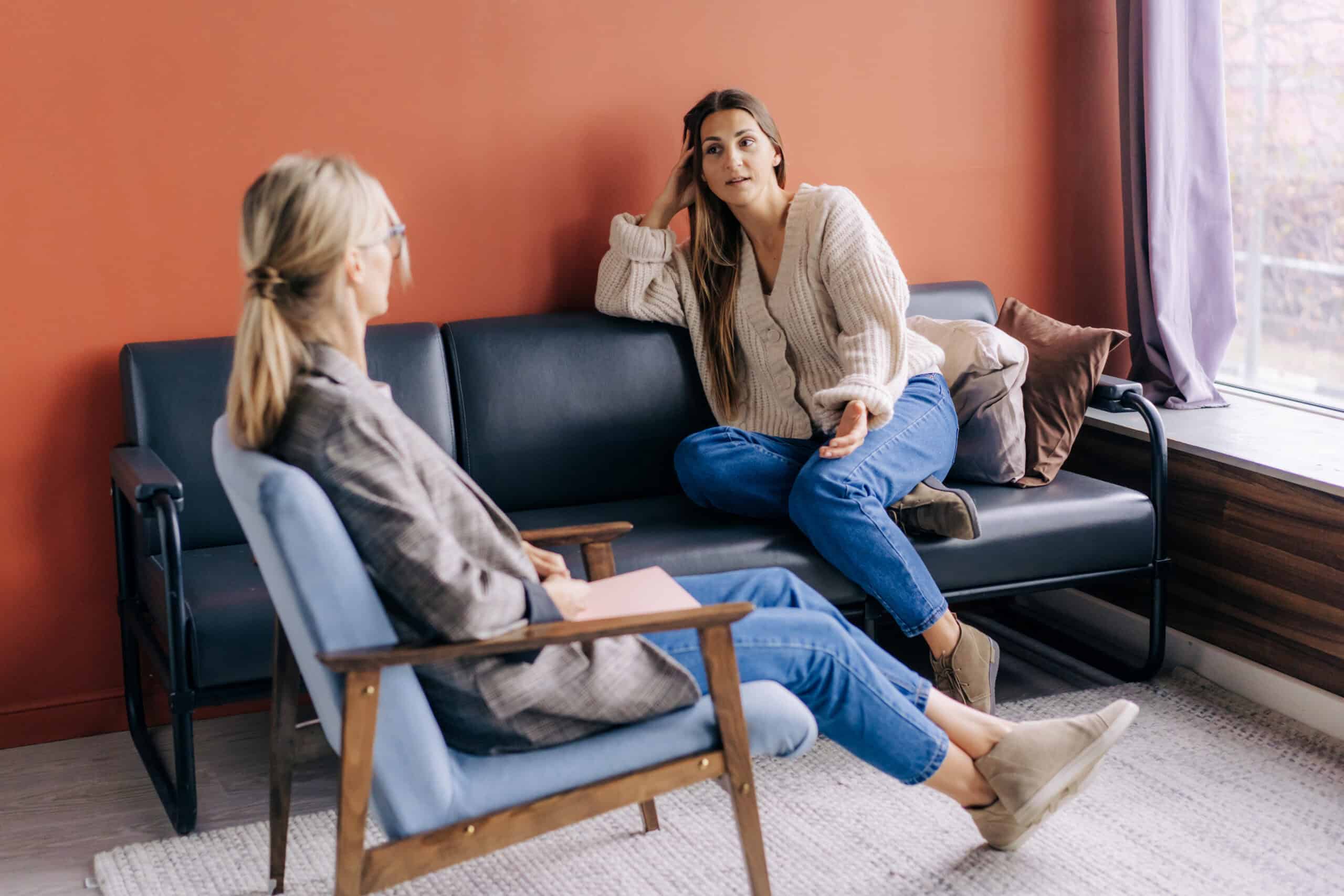 A woman talks openly with her therapist during a supportive counseling session.