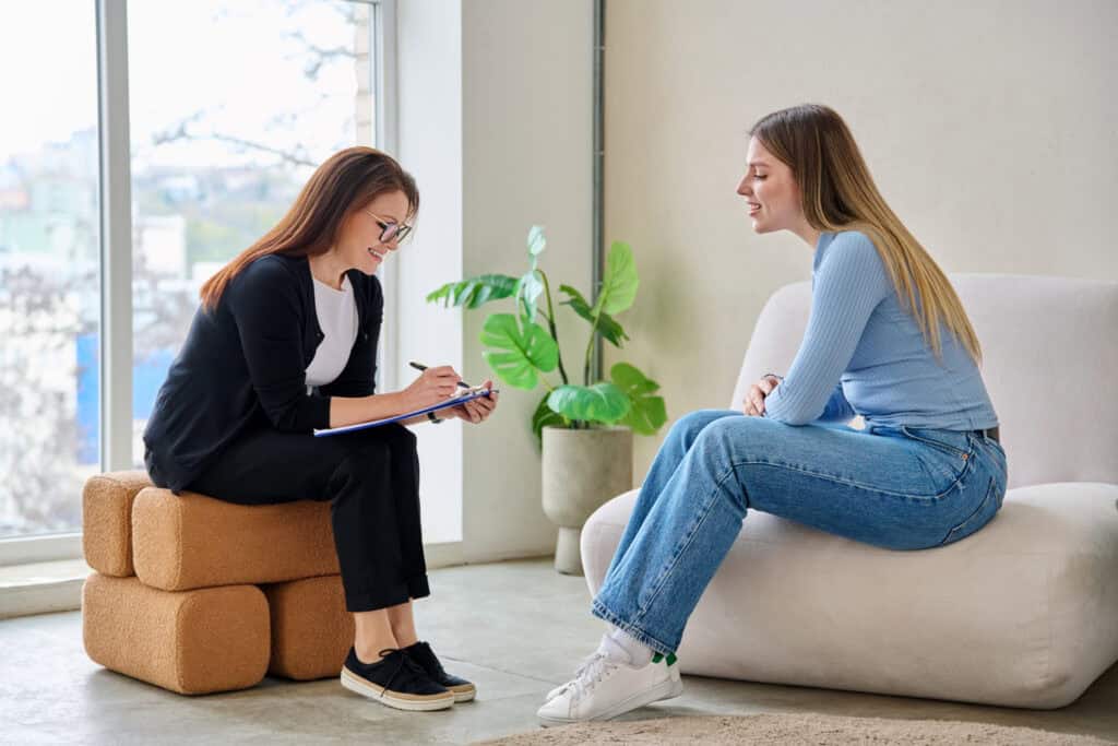 Person weighing the difference between PHP and IOP levels of care with a counselor