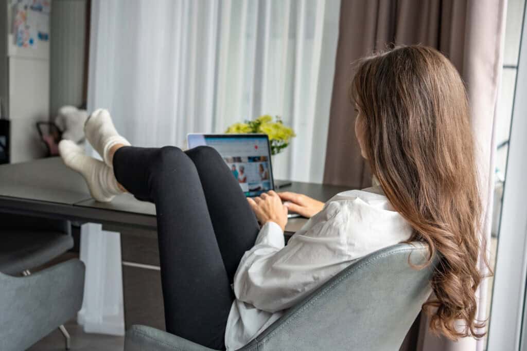 Person attending a virtual IOP telehealth session in California from home