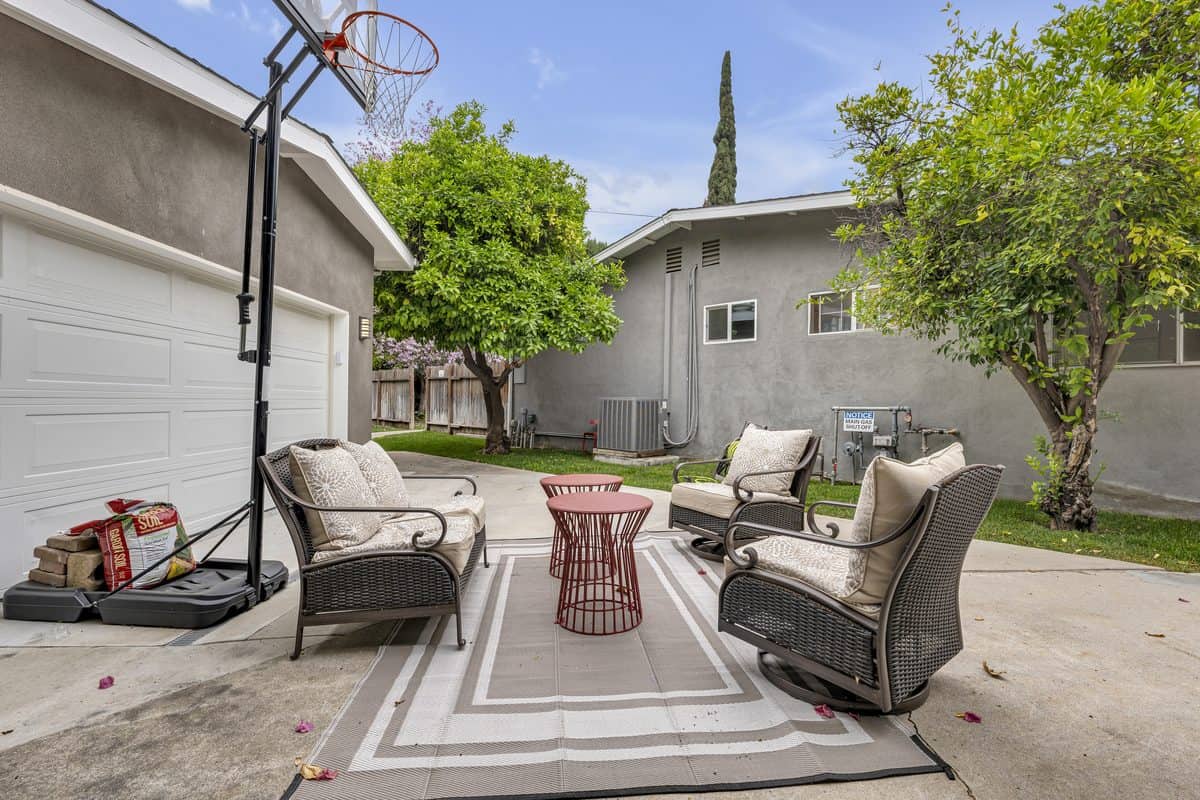 A backyard patio with seating at one of our homes